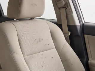A fabric car seat with a few loose hairs